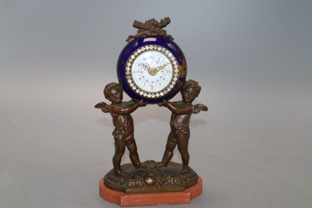 A French porcelain and bronze putti mantel clock, with diamonte decoration to the dial, height 20cm